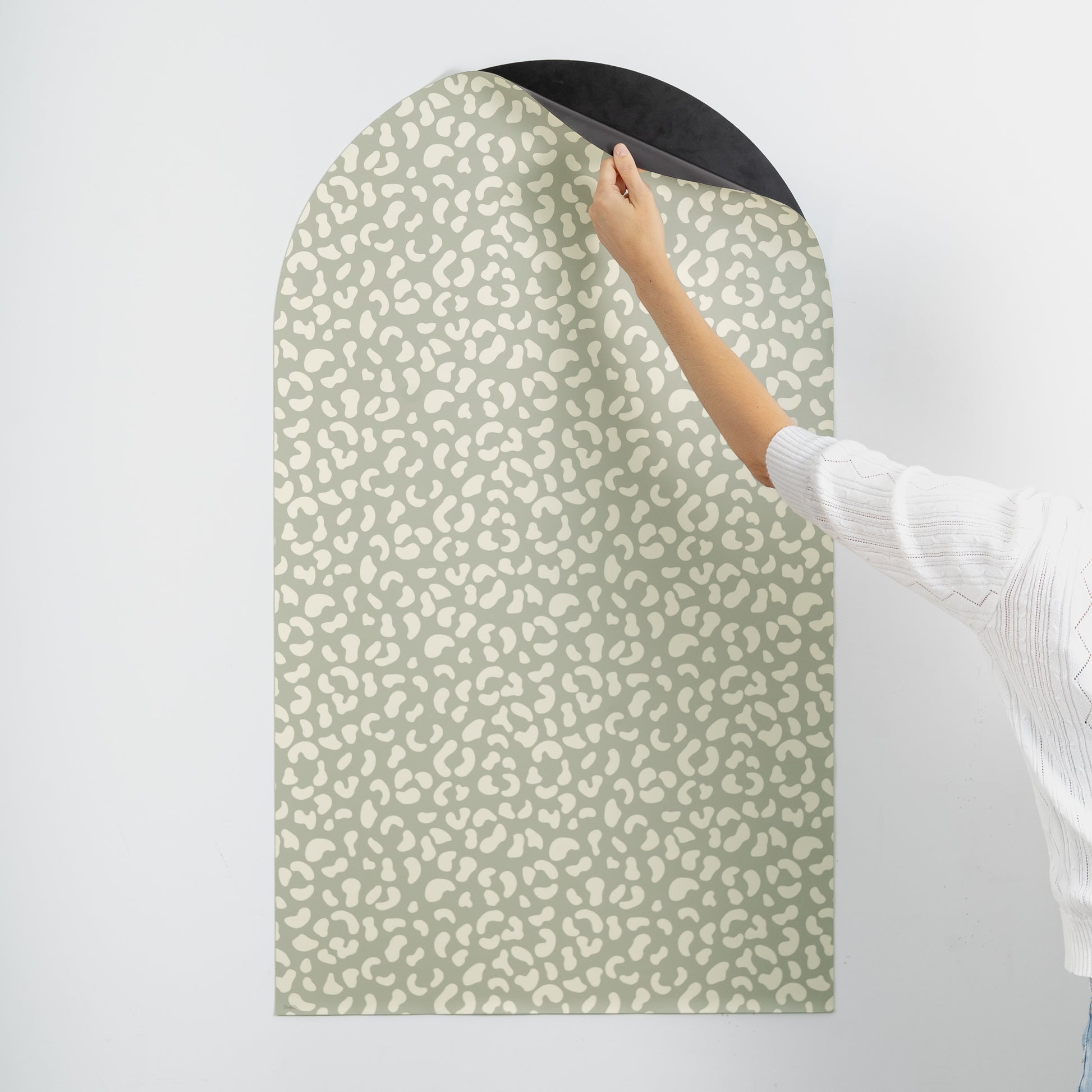 Tableau magnétique mural graou vert avec main soulevant le coin du revêtement