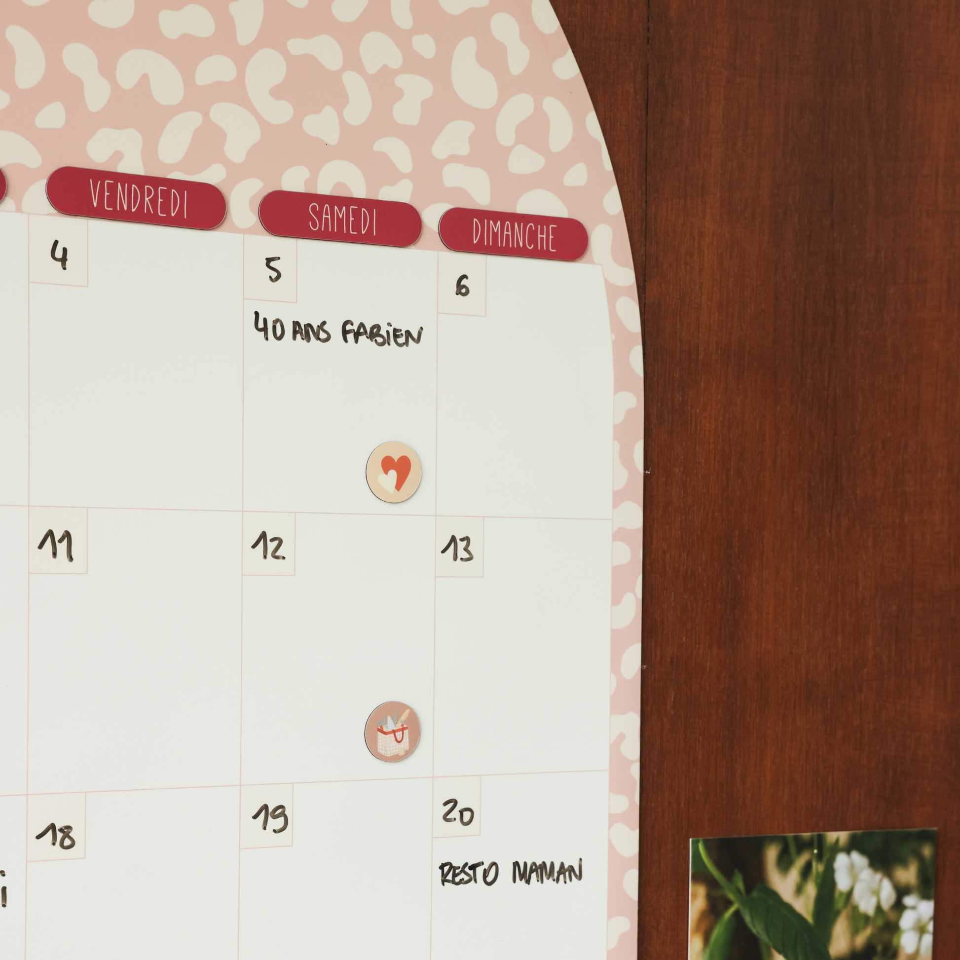 Détail du calendrier mensuel magnétique en forme d’arche avec les jours de la semaine.